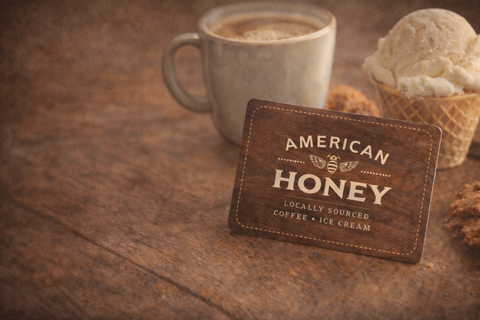 American Honey branded card with a cup of coffee and ice cream on a wooden surface